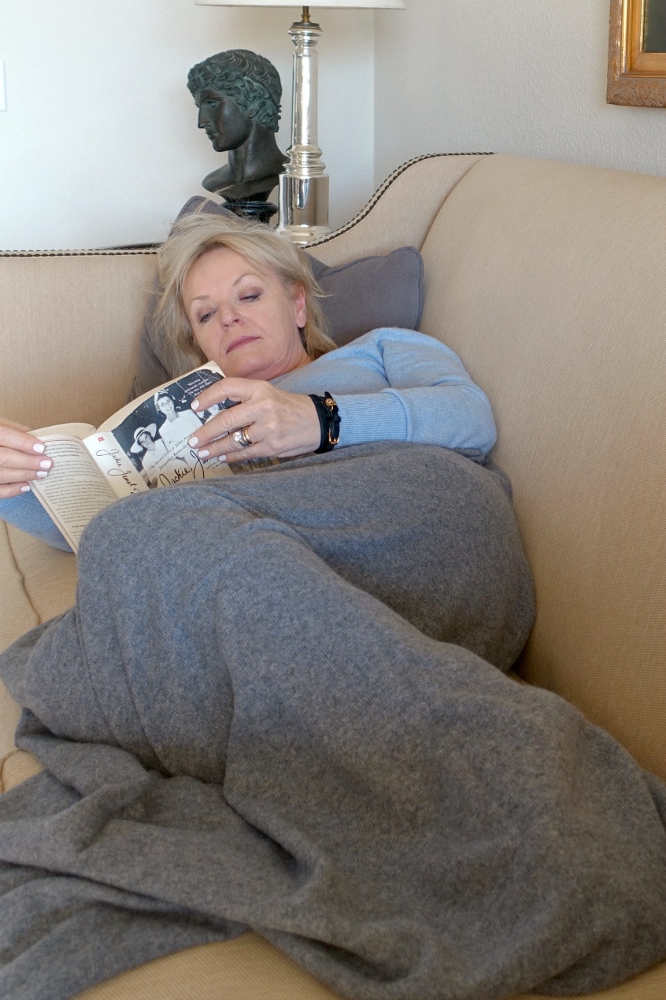 Jennifer Connolly reading with Cashmere wrap over her legs