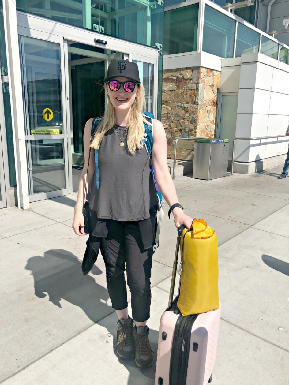 woman at airport with carry on for trip to Africa
