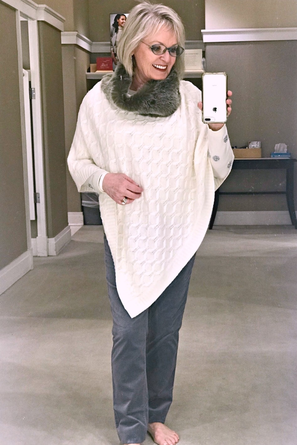 ivory poncho over gray velveteen pants