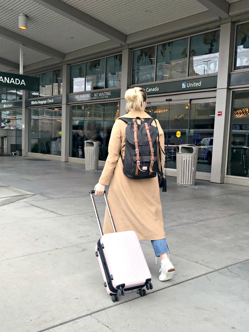 entering airport with backpack and travel spinner from Nordstrom