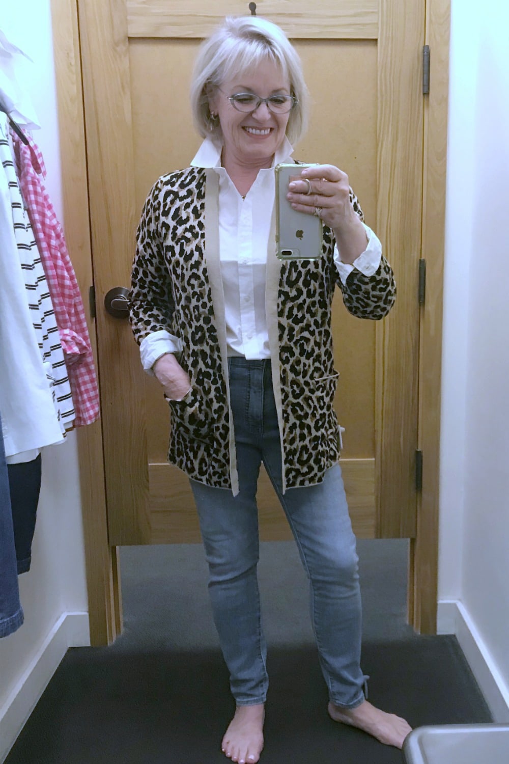 Jennifer Connolly of A Well Styled life wearing leapoard cardigan over white shirt and blue jeans