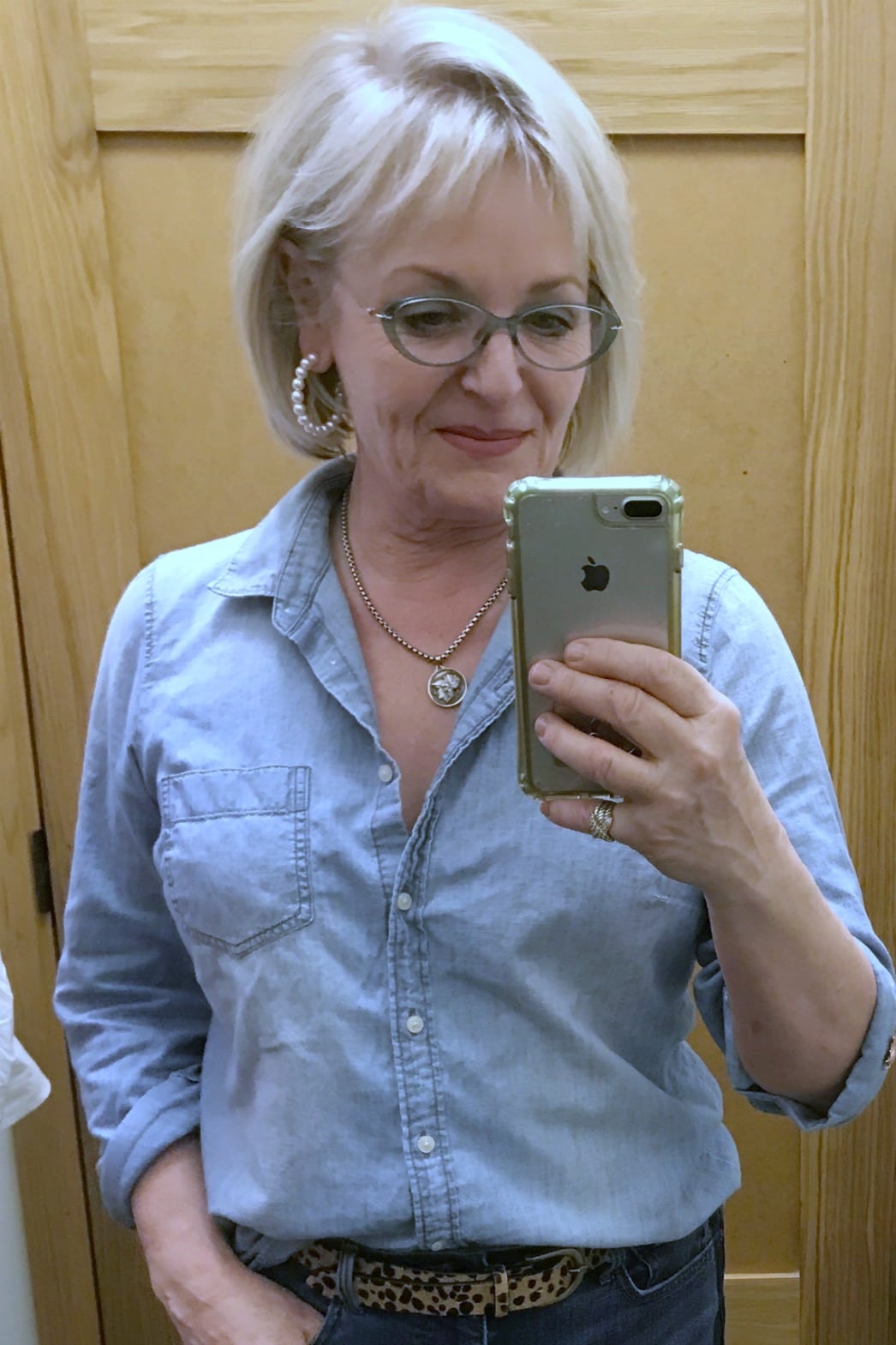 Jennifer Connolly of A Well Styled Life wearing pearl hoop earrings, denim shirt and leopard belt