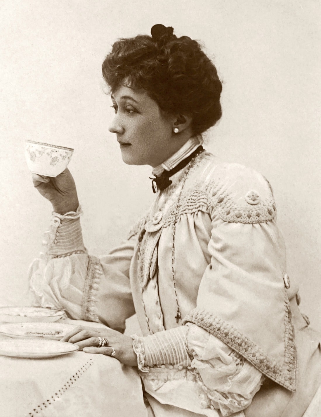 woman dressed formally drinking tea