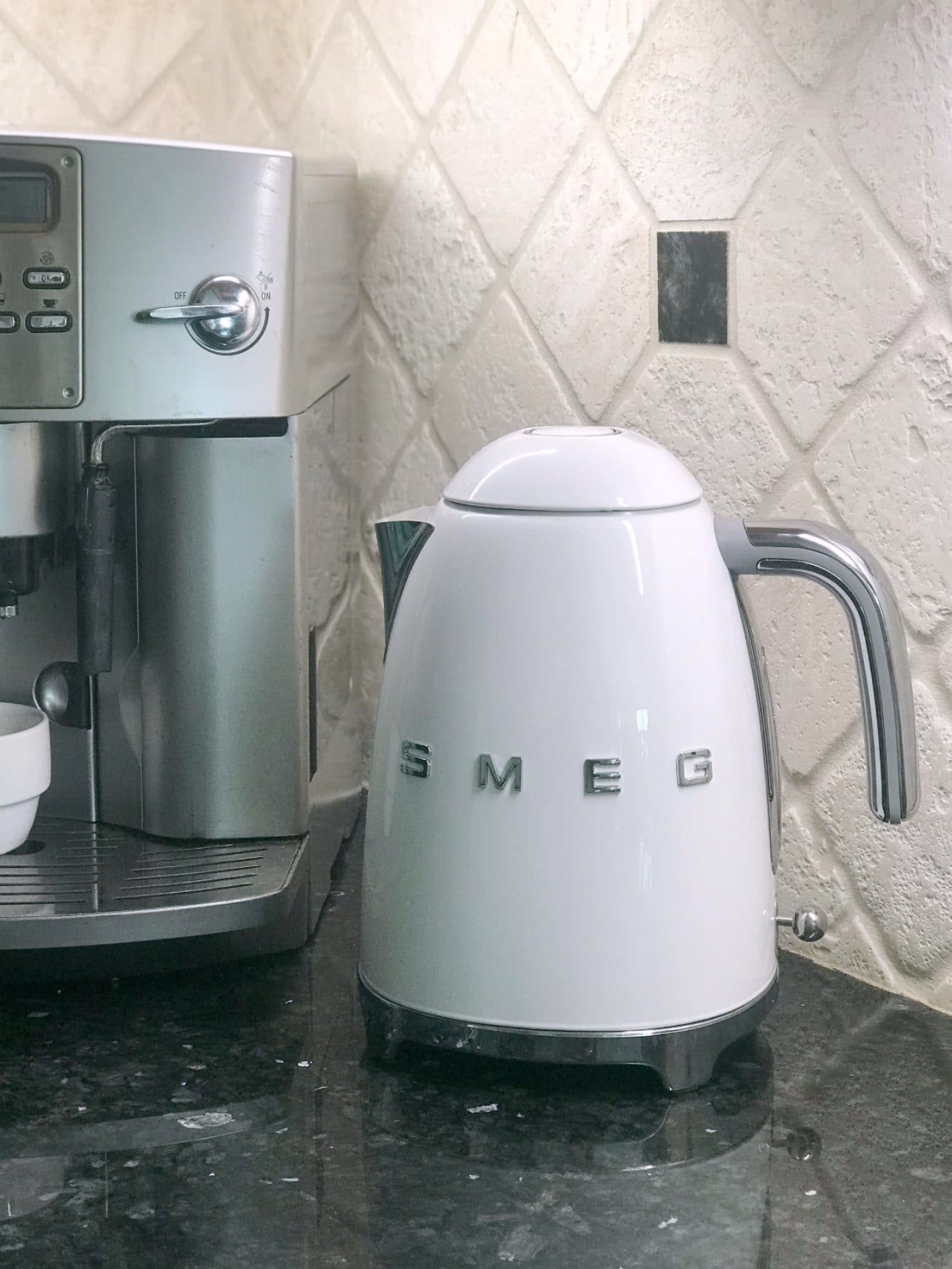 white smeg tea kettle on counter next to espresso machine
