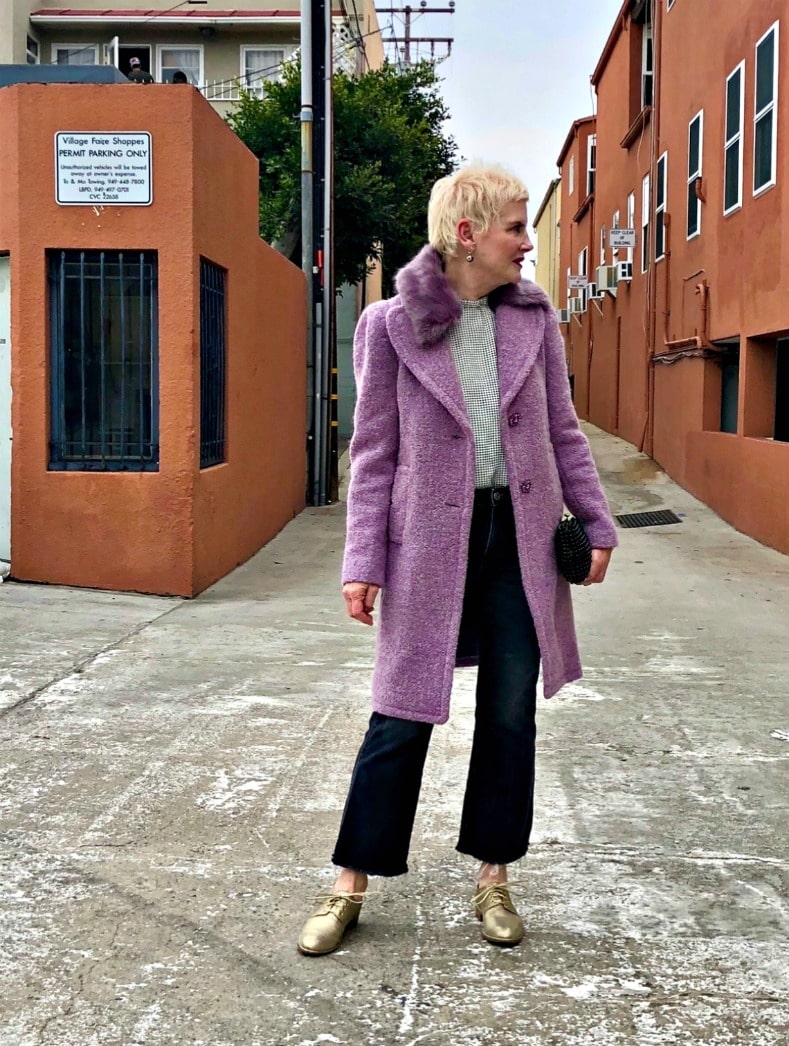 blone woman in purple coat and black pants