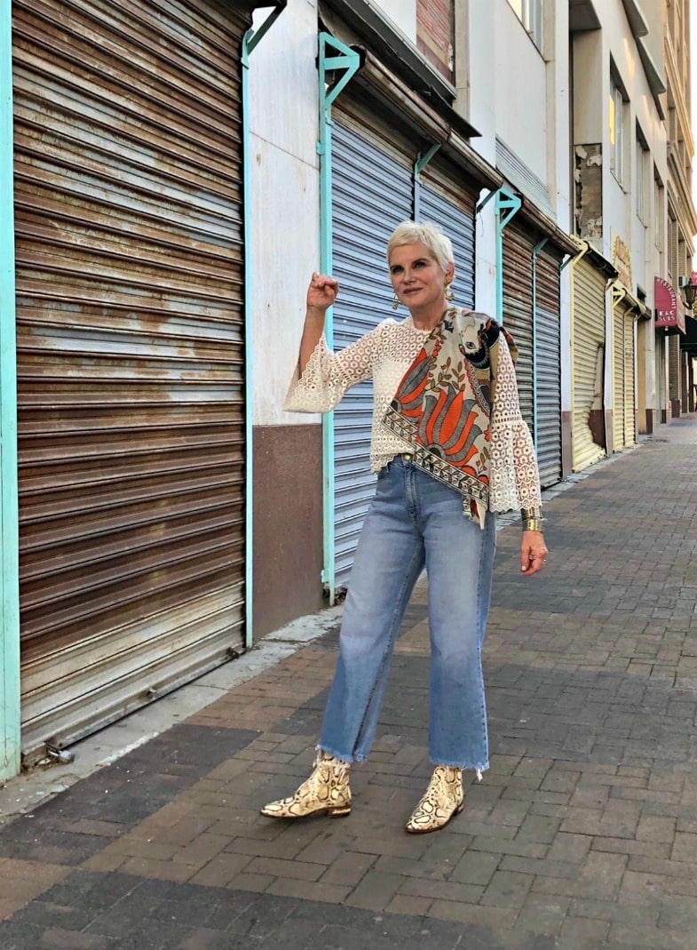 woman in snake print boots and denim