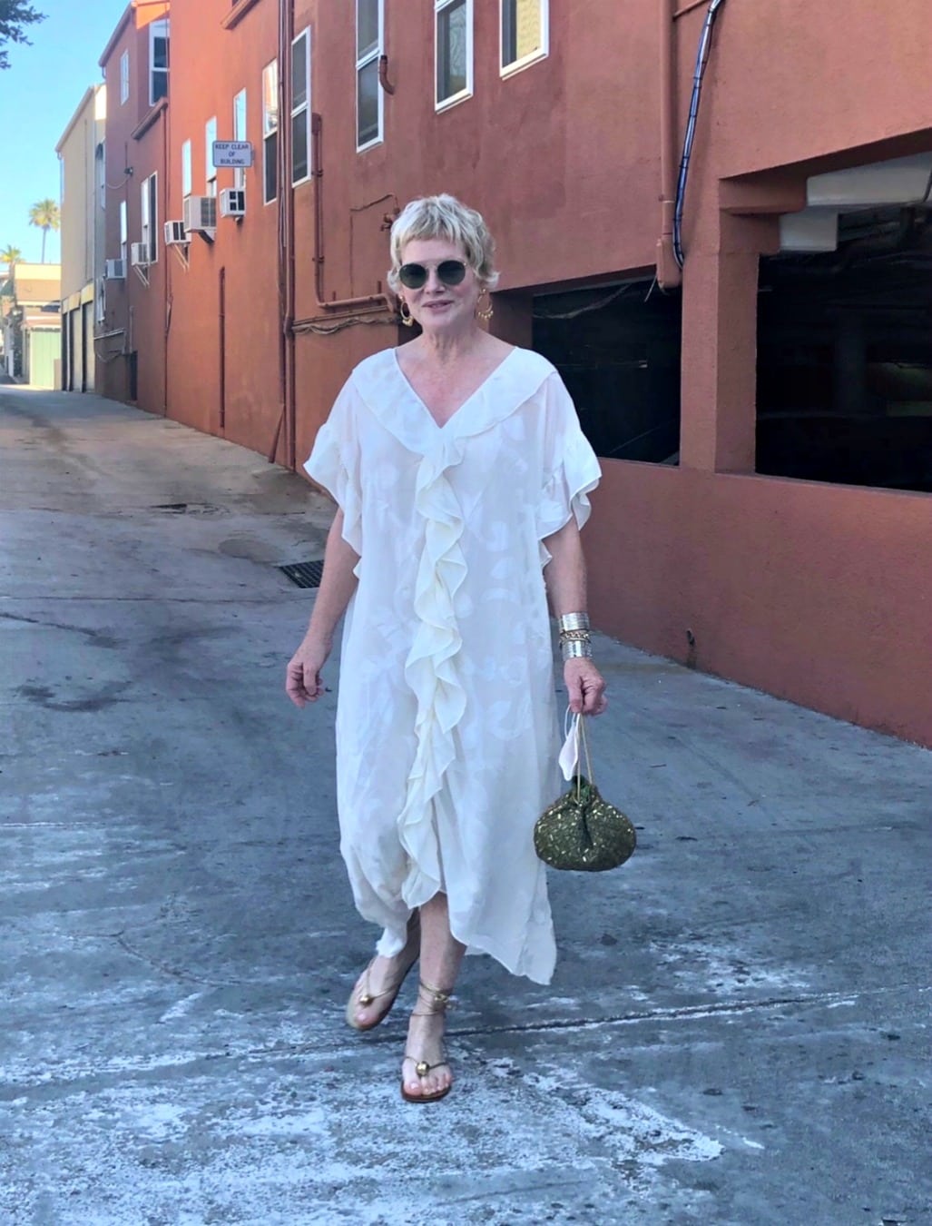 woman in white dress and gold sandals