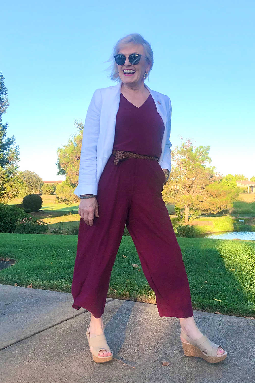 fashion blogger Jennifer Connolly wearing white blazer over burgundy jumpsuit