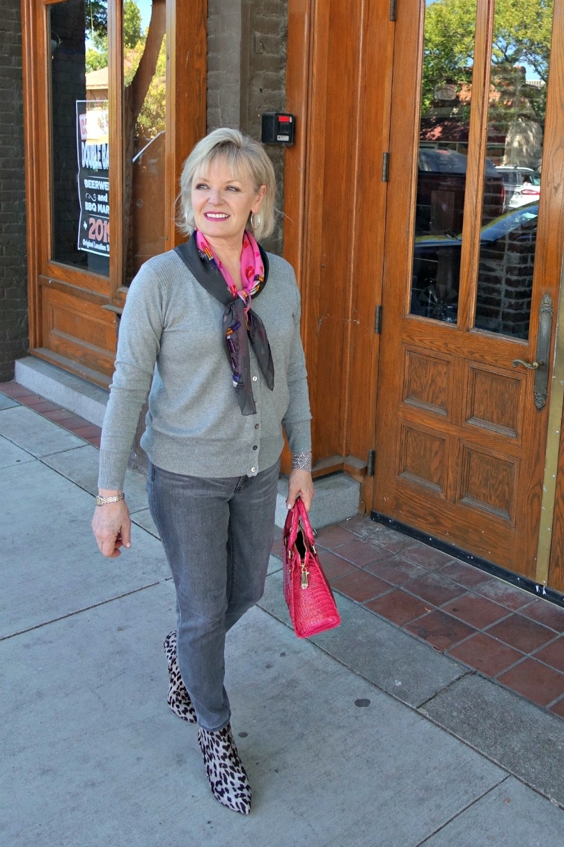 woman wearing gray sweater, scarf, gray jeans and leopard booties
