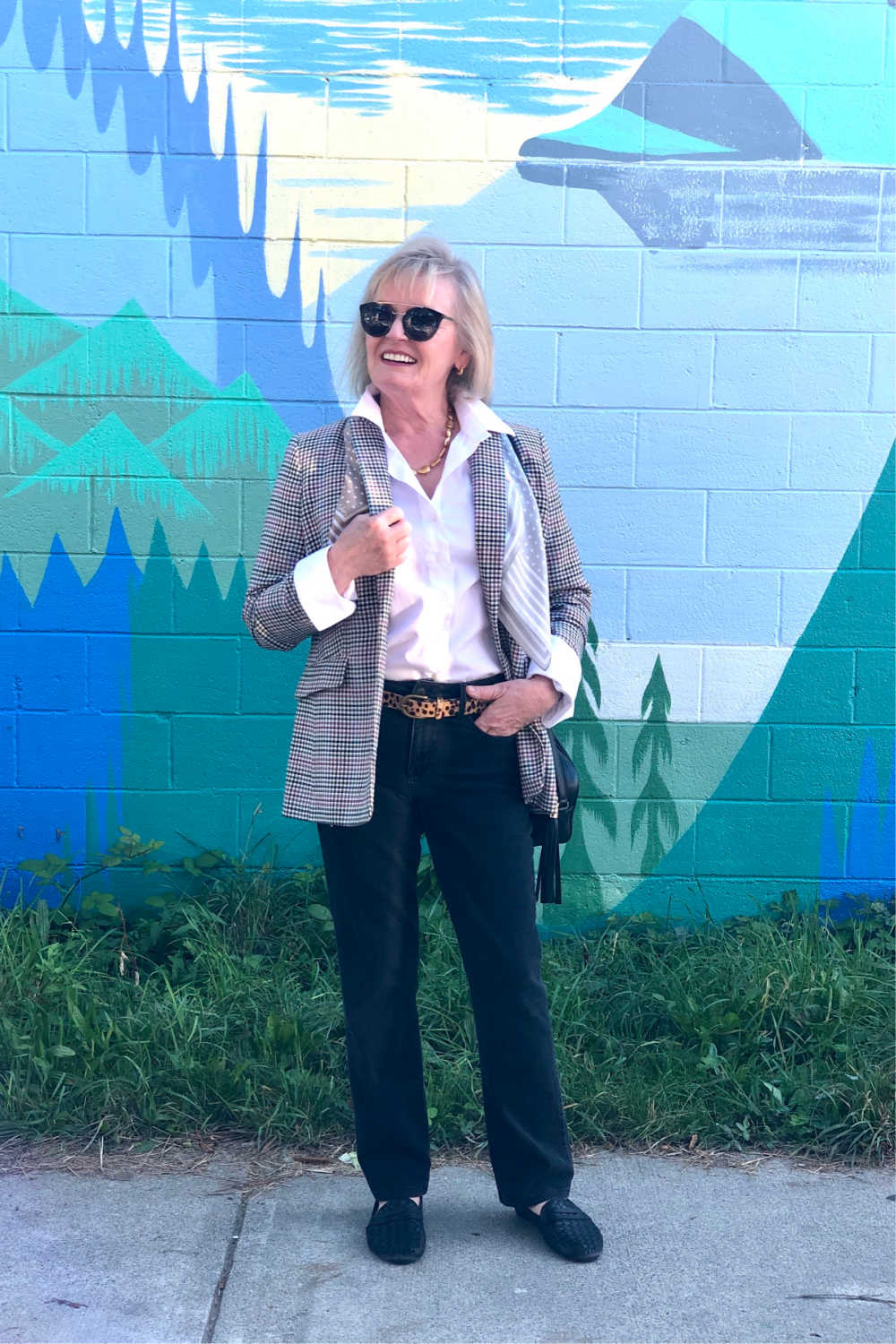 woman standing in front of vancouver mural wall