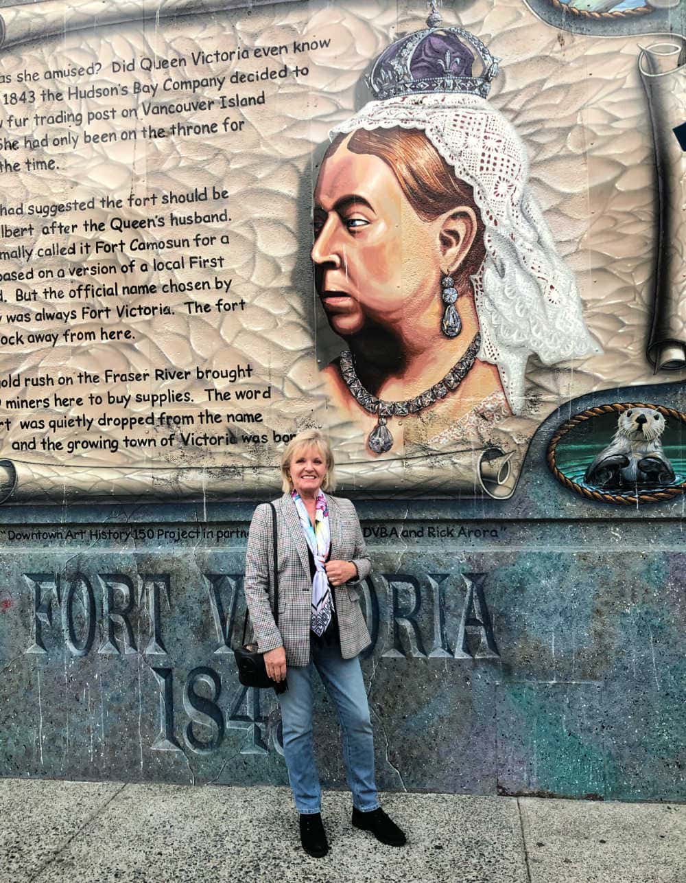 fashion blogger jennifer connolly in victoria bc in front of mural of queen victoria