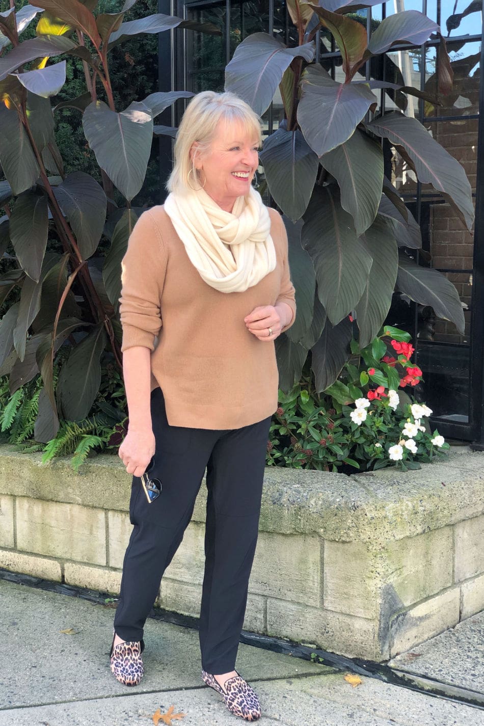 fashion blogger jennifer connolly of a well styled life wearing casual outfit of ahlogen camel sweater, black zella pants and caslon leopard shoes