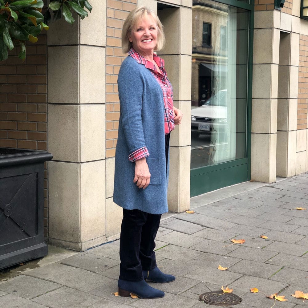 duster sweater and blue cords on woman