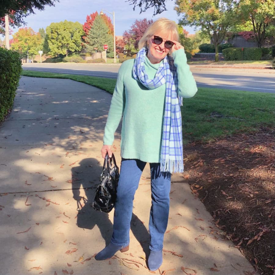 fashion blogger jennifer connolly of a well styled life wearing plaid scarf, boot cut jeans and tunic sweater