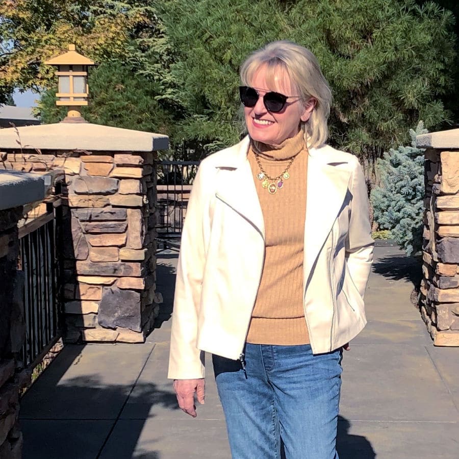 jennifer of well styled life wearing camel colored turtleneck, cream colored jacket and sunglasses