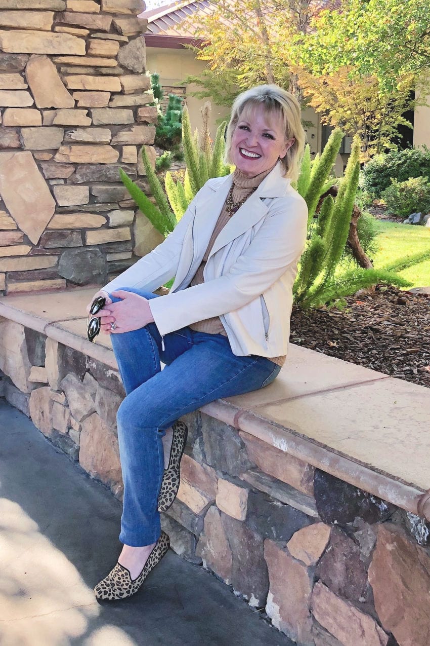 over 50 fashion blogger wears Chico's faux leather jacket with jeans