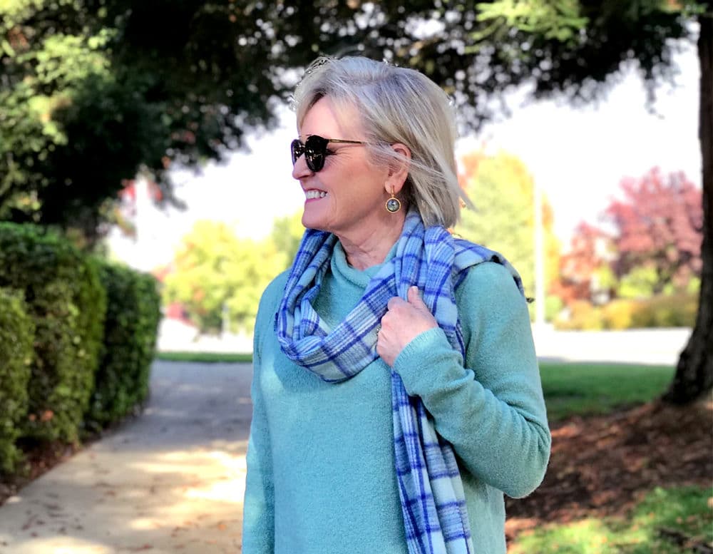 jennifer of a well styled life wearing dean davidson earrings plid scarf and aqua sweater
