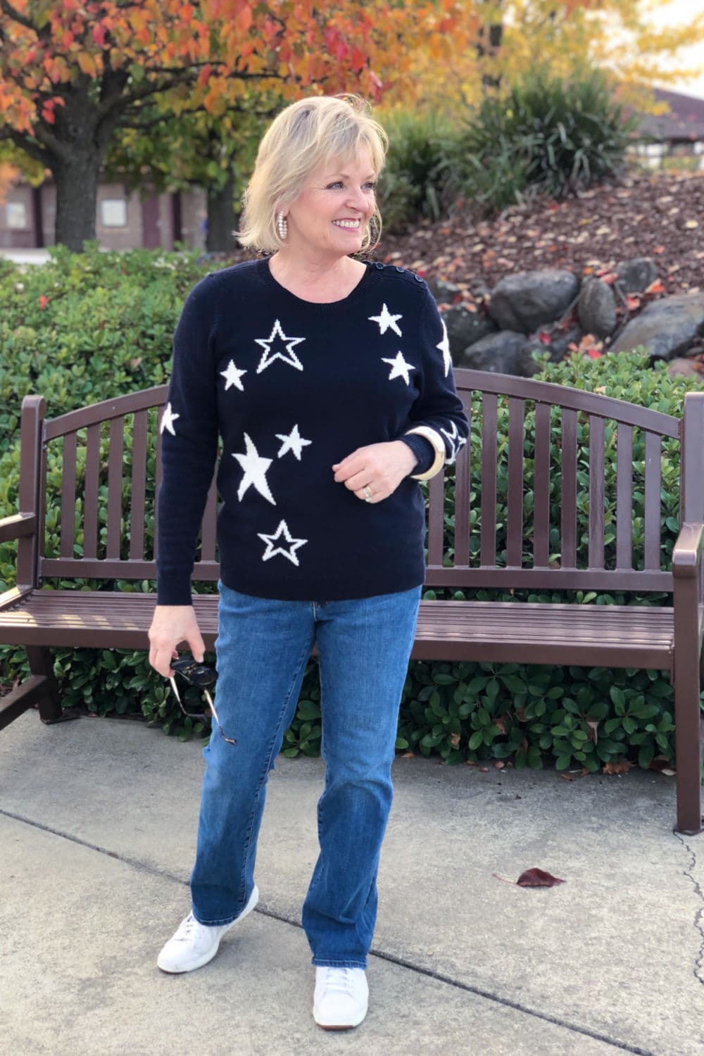 fashion blogger jennifer of a well styled life wearing navy starw sweater and blue jeans