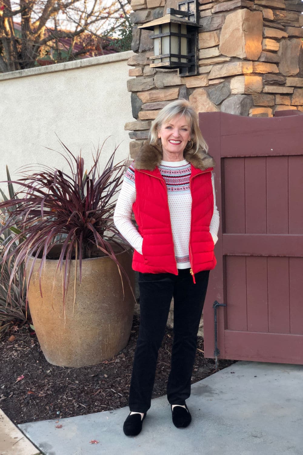 over 50 fashion blogger jennifer connolly wearing talbots nordic fair isle sweater with faux fur down puffer vest in red