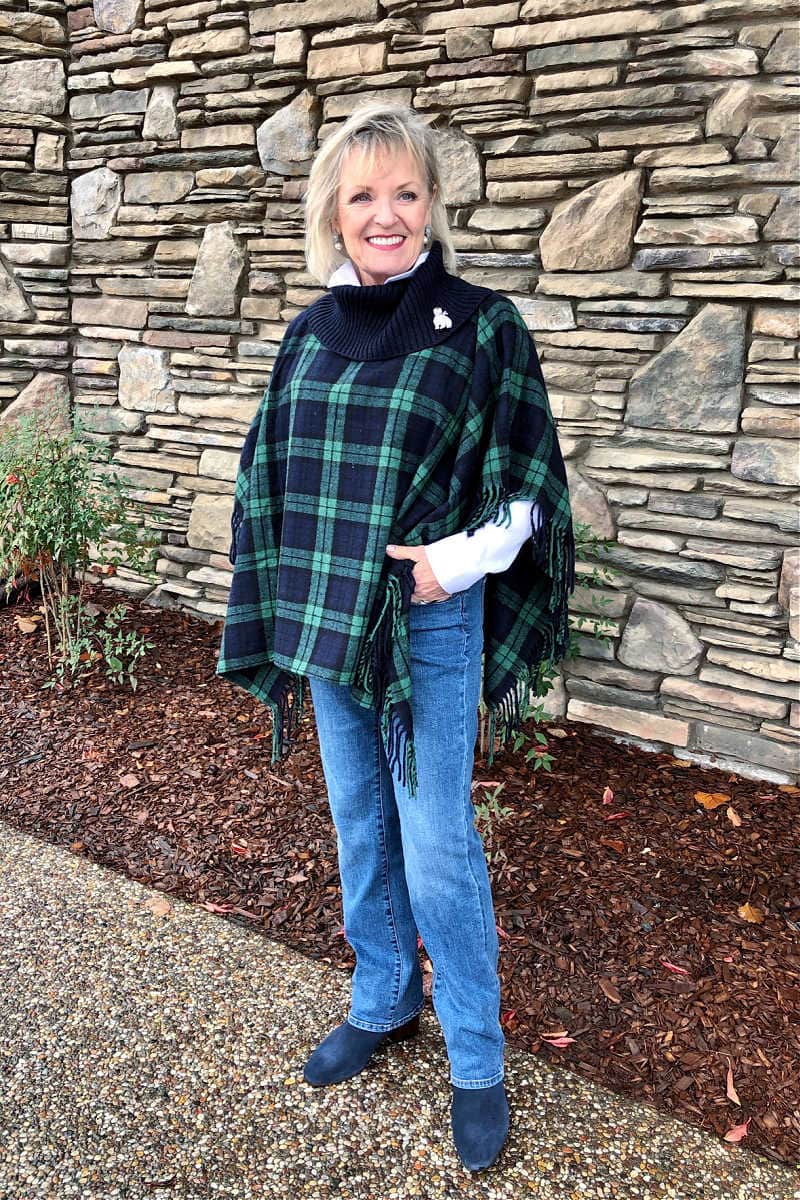 over 50 fashion blogger jennifer of a well styled life wearing blue jeans with black watch plaid poncho from Talbots