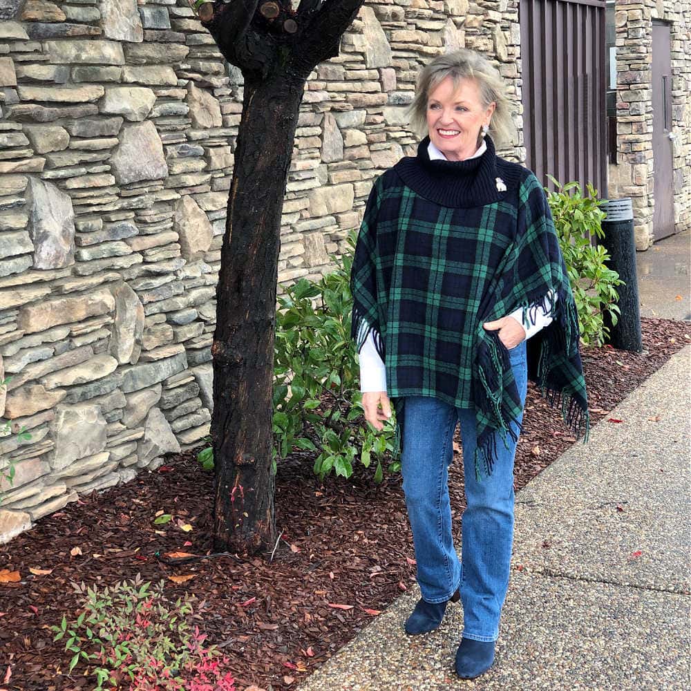 fashion blogger jennifer of a well styled life wearing talbots black watch plaid poncho and barely boot jeans