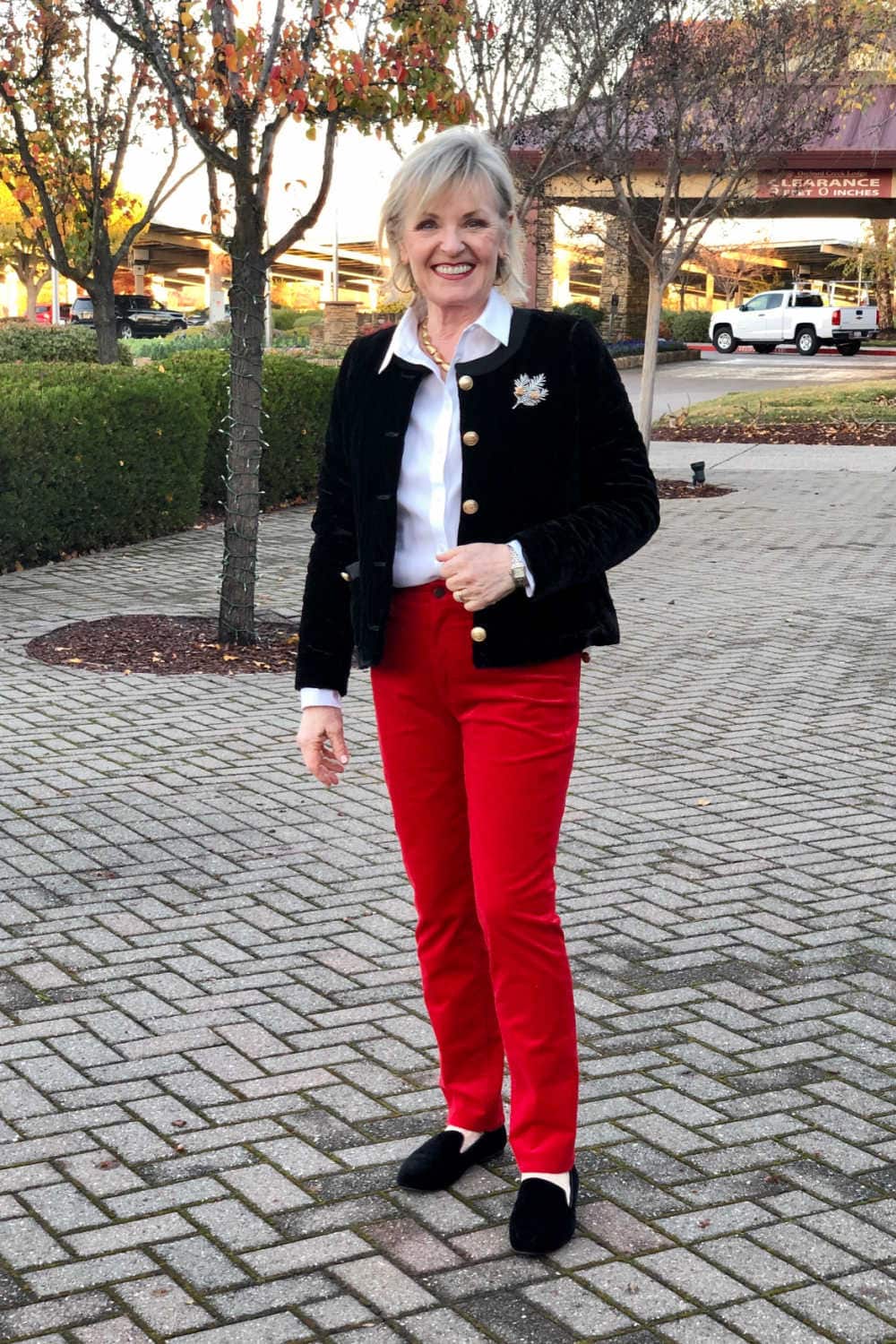 over 50 fashion blogger jennifer of a well styled life wearing talbots red pants and black jacket