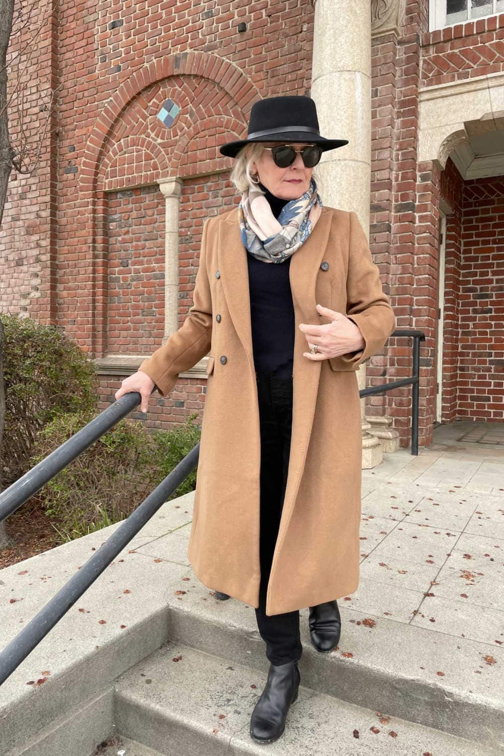 camel coat over black sweater, jeans and boots on Jennifer or a well styled life
