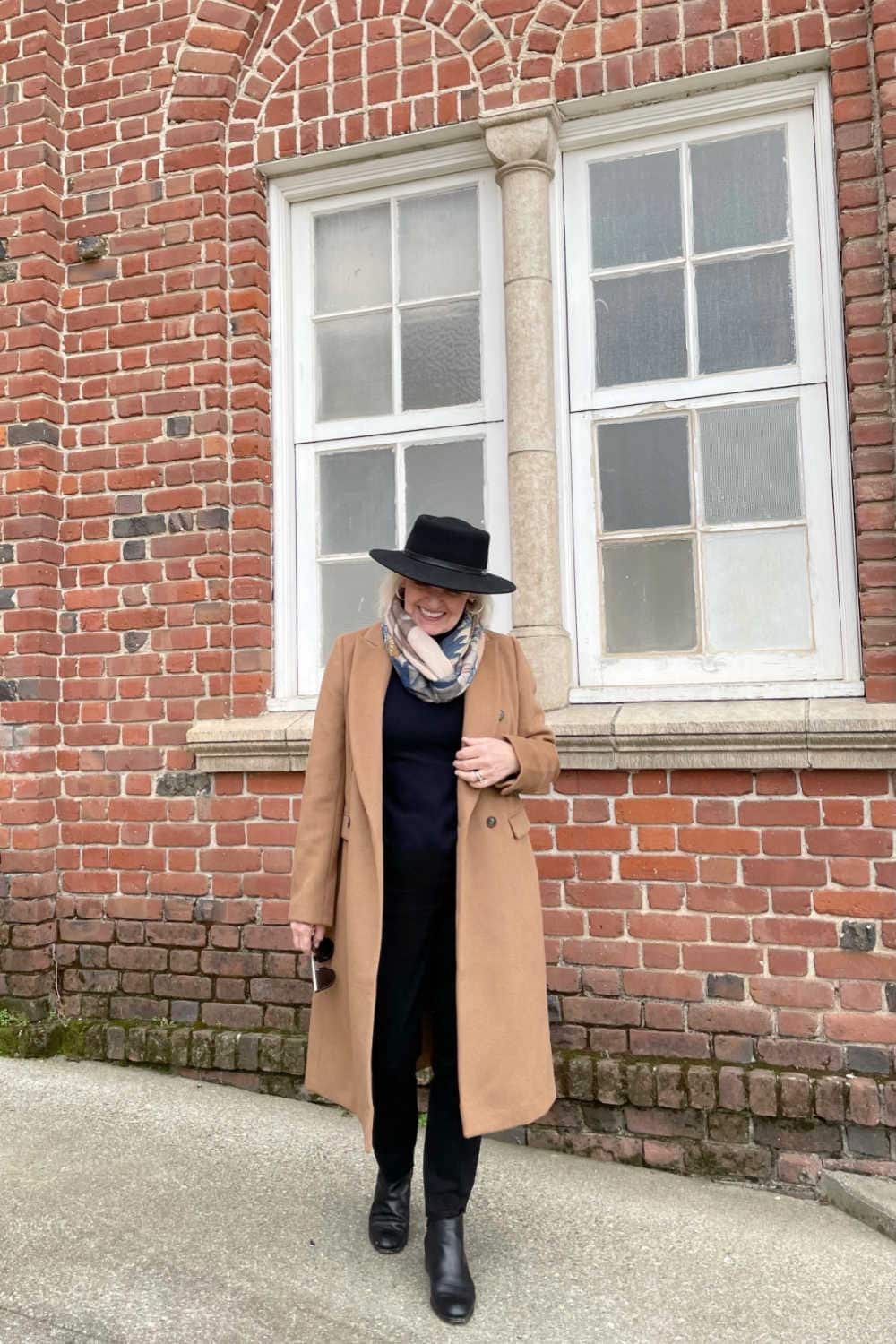 classic camel coat over a column of black