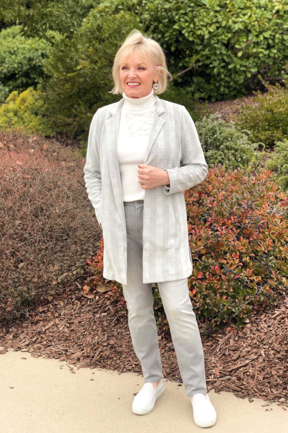 over 50 fashion blogger wearing gray jacket and jeans on a well styled life