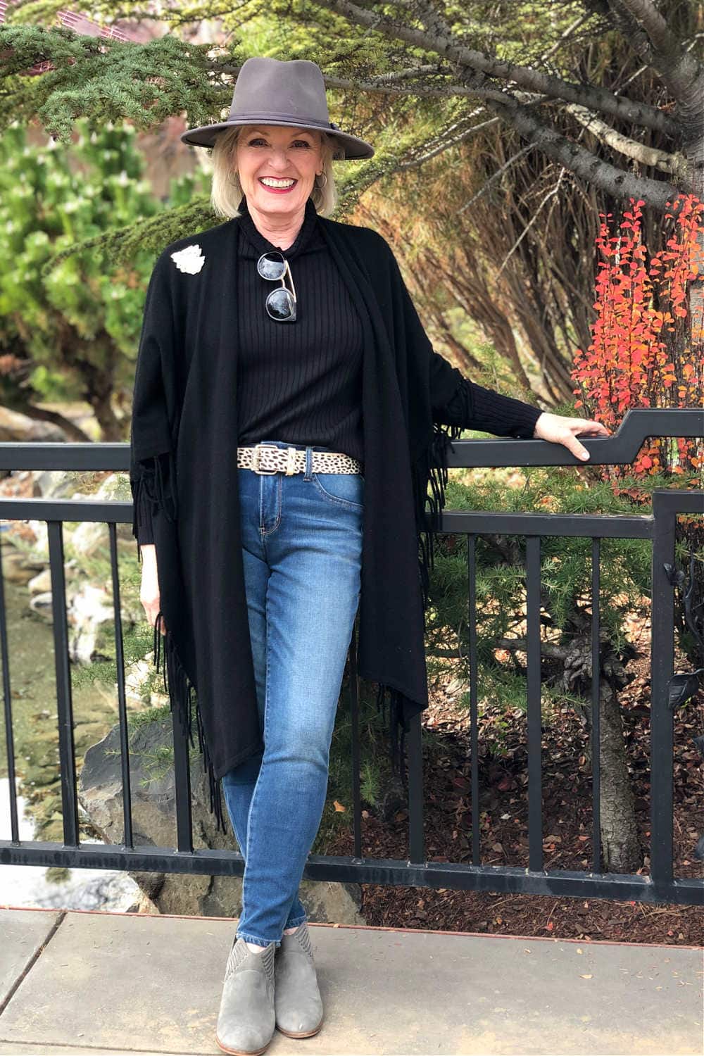 over 50 fashion blogger jennifer of a well styled life wearing grey fedora and black ruana