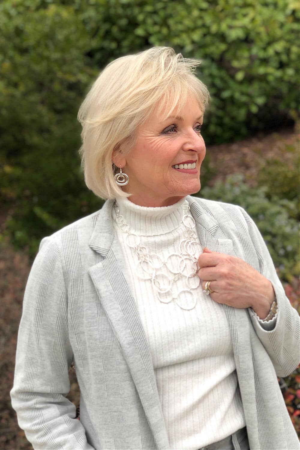 midlife blogger jennifer of a well styled life wearing Chico's gray jacket with silver jewelry