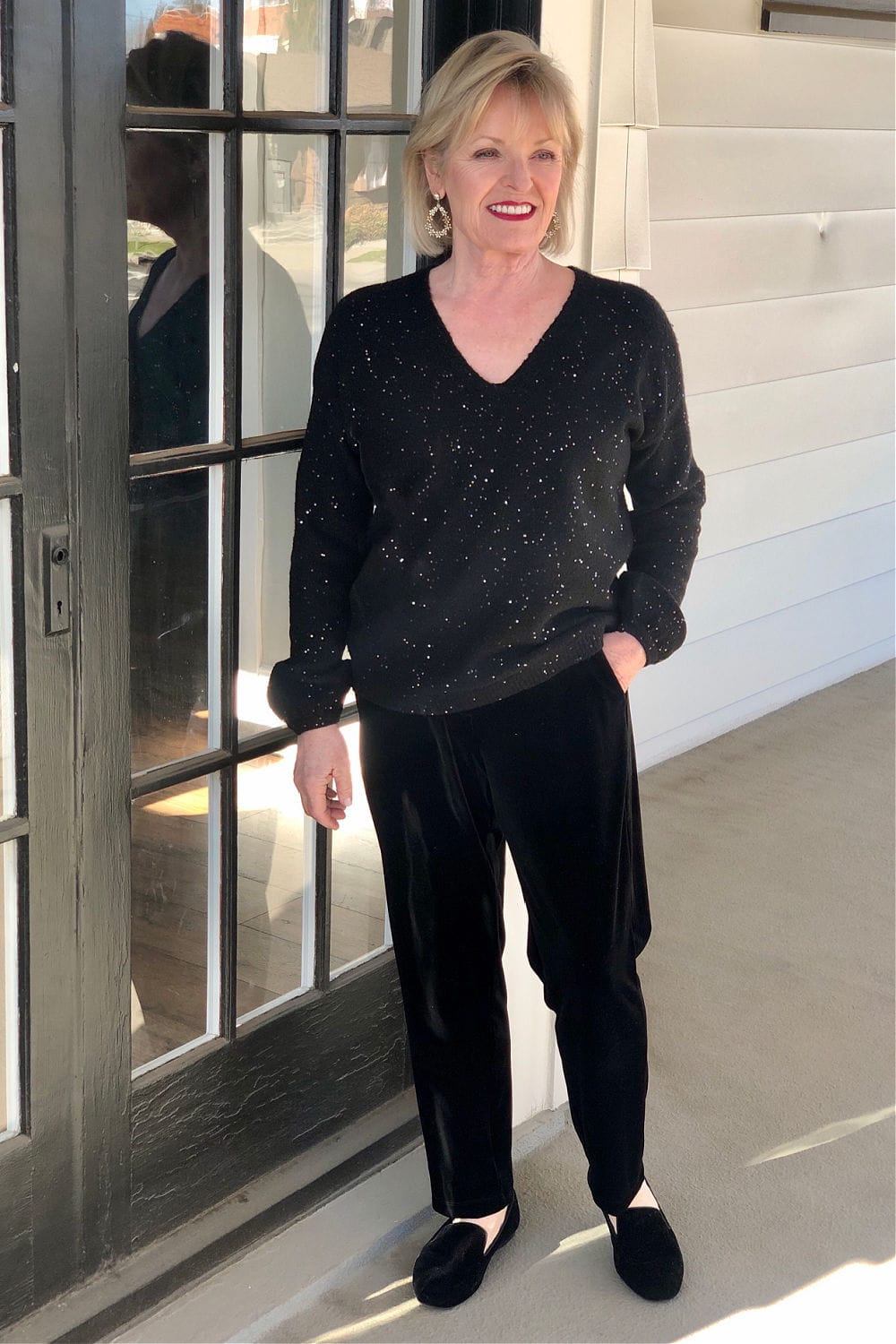 over 50 woman wearing black sweater pants and shoes