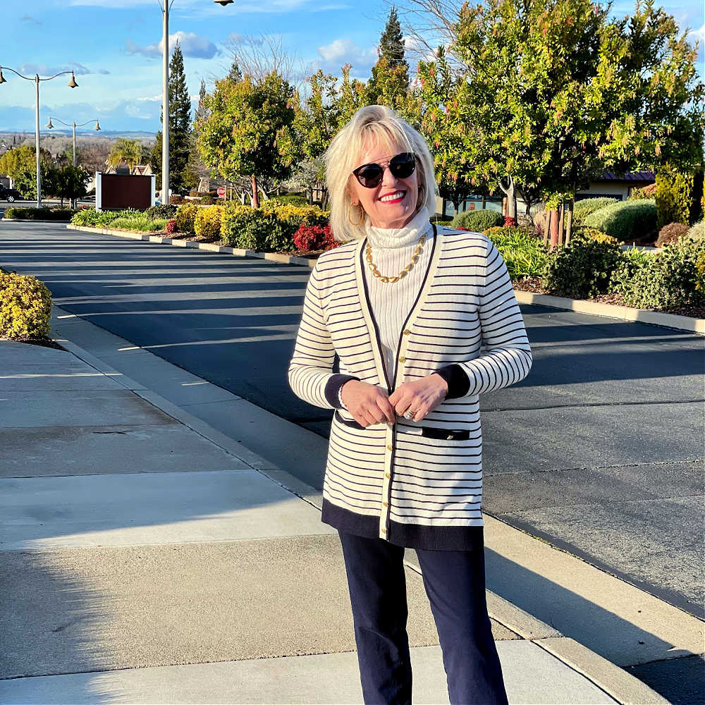blonde woman wearing striped cardigan and turtleneck