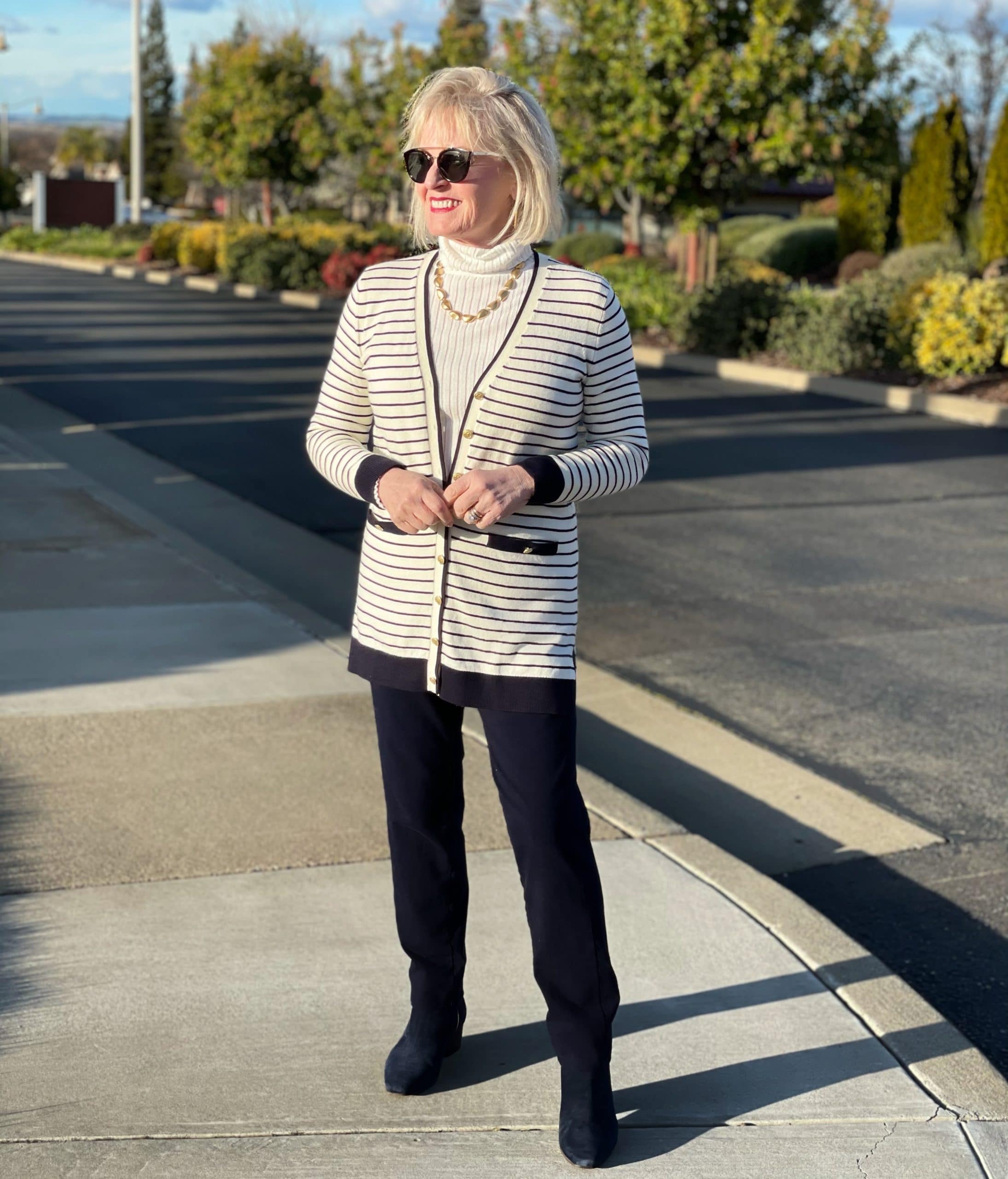 woman wearing striped caridan with yoga pants and gold necklace