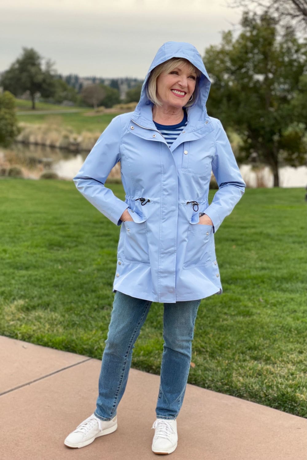 woman wearong hood up on blue rain coat