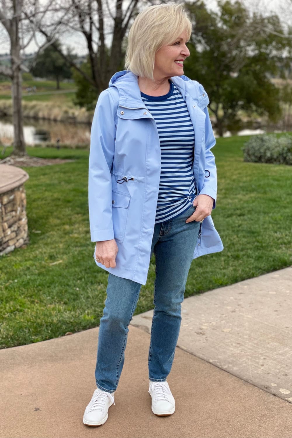 woman wearing blue stried top, blue jeans, and blue coat
