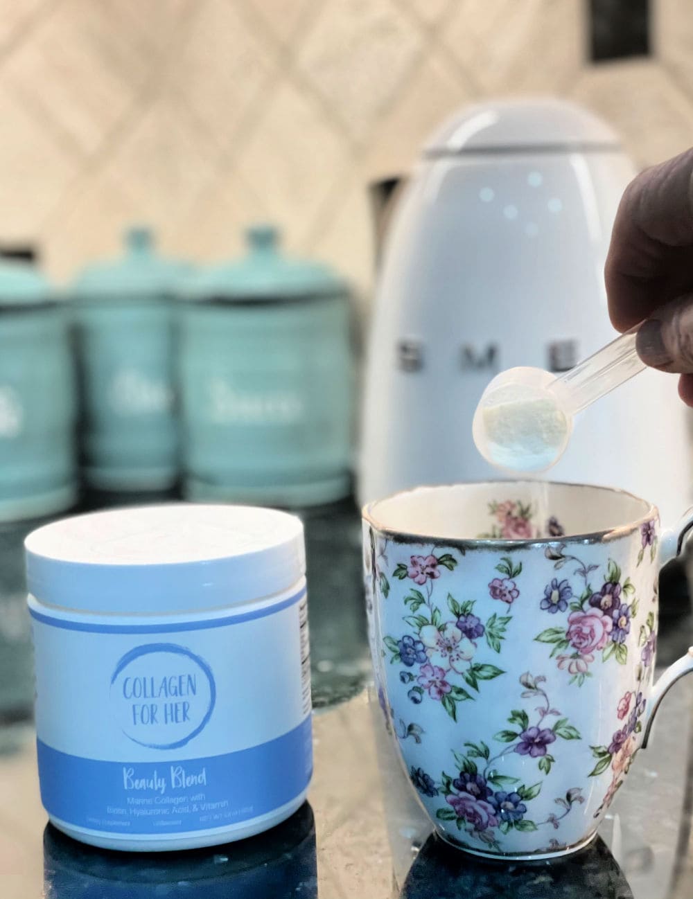 scoopful of collagen for her marine blend pouring into tea cup