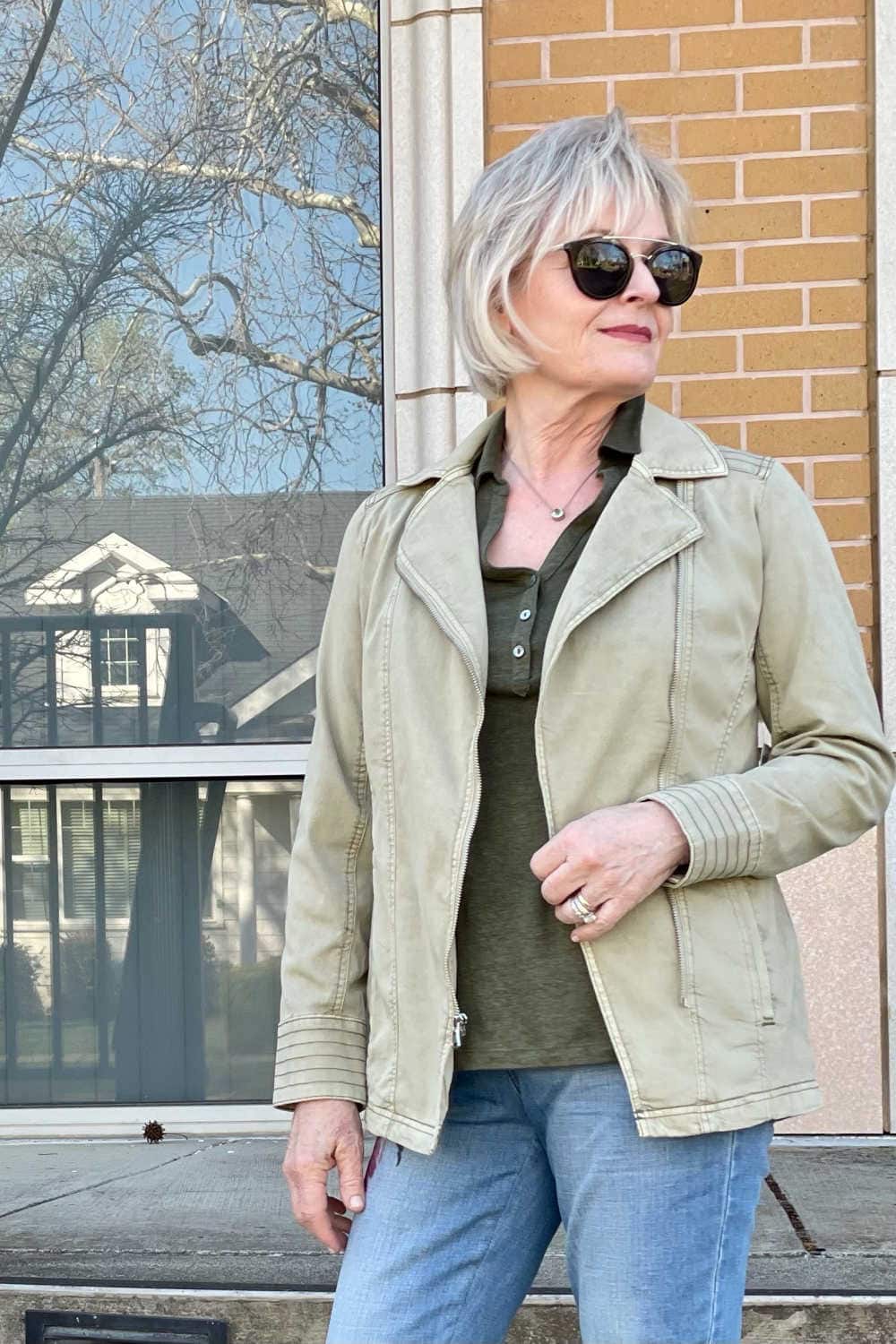 over 50 fashion blogger wearing green jacket and sunglasses