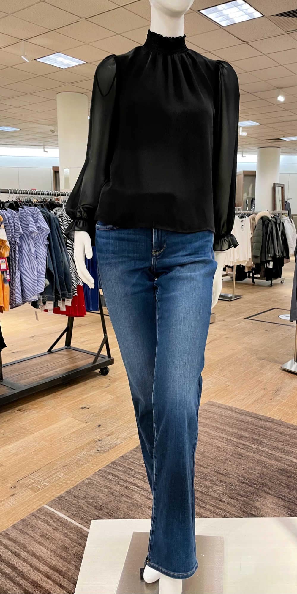 mannequin modeling black top and jeans