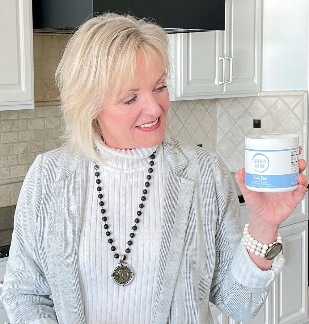 blonde woman holding up jar of collagen for her powder