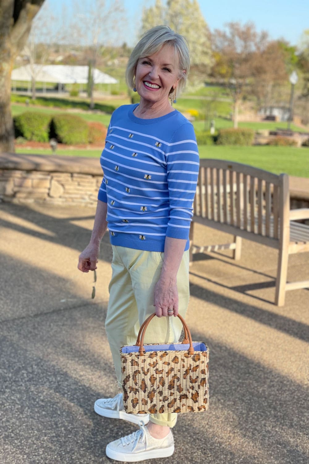 woman wearing yellow pants and blue bee sweater