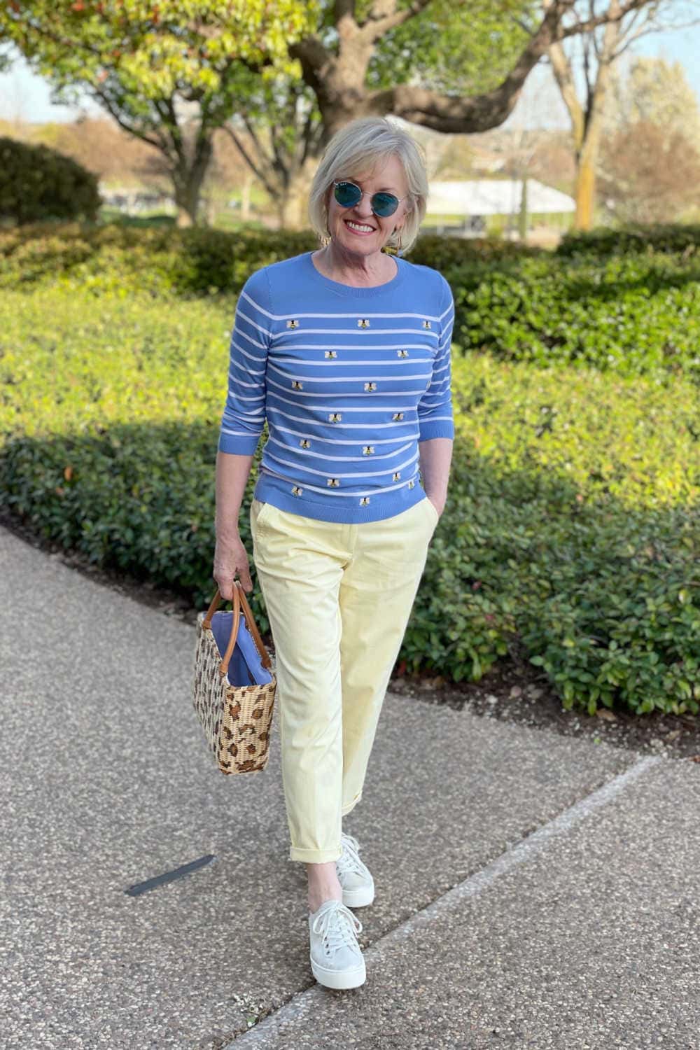woman walking in blue sweater and casual chinos for spring