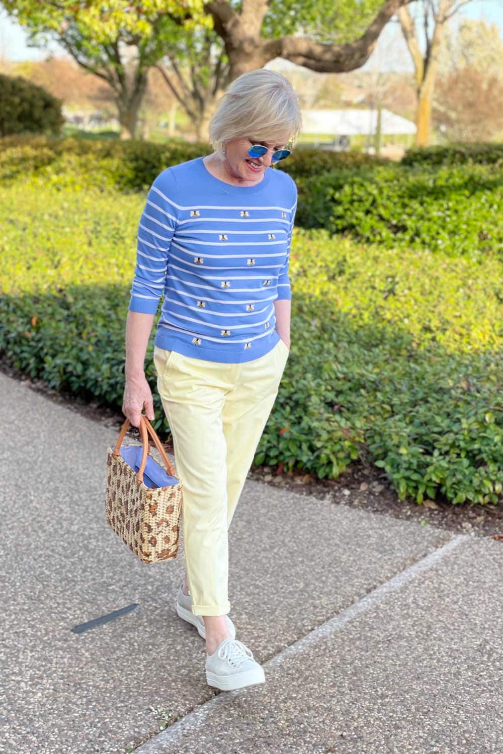 blonde lady wearing Talbots bee sweater with yellow chinos