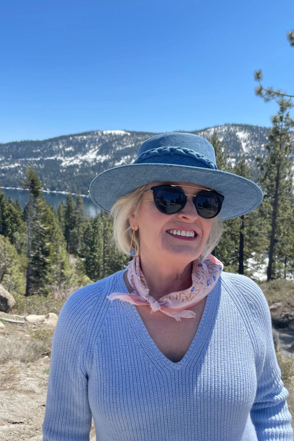 woman wearing denim hat and blue sweater