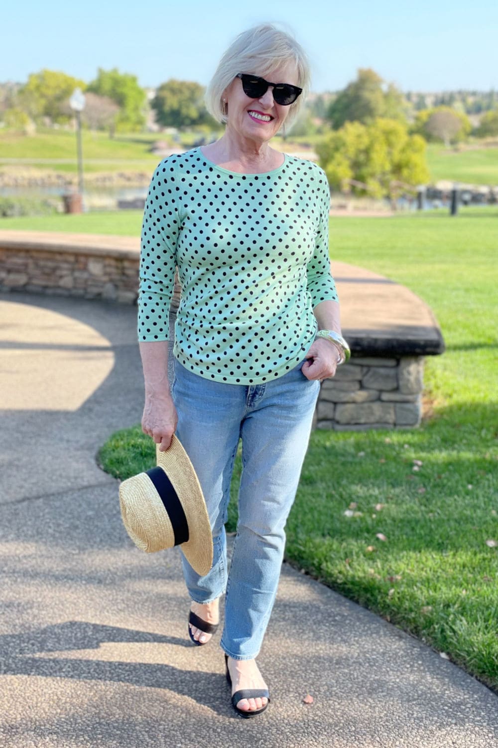 woman walking on path wearing causal green polka dots