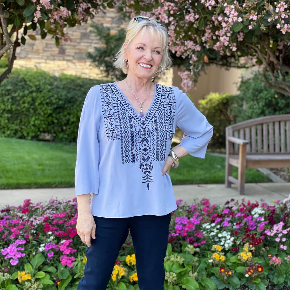 blonde women wearing purple embroidered top