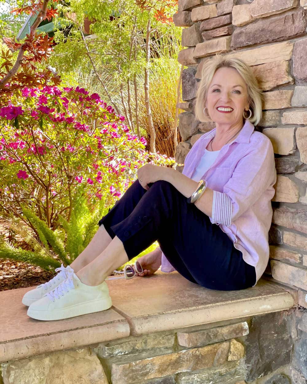 blonde woman wearing purple no-iron linen shirt and line pants with sneakers
