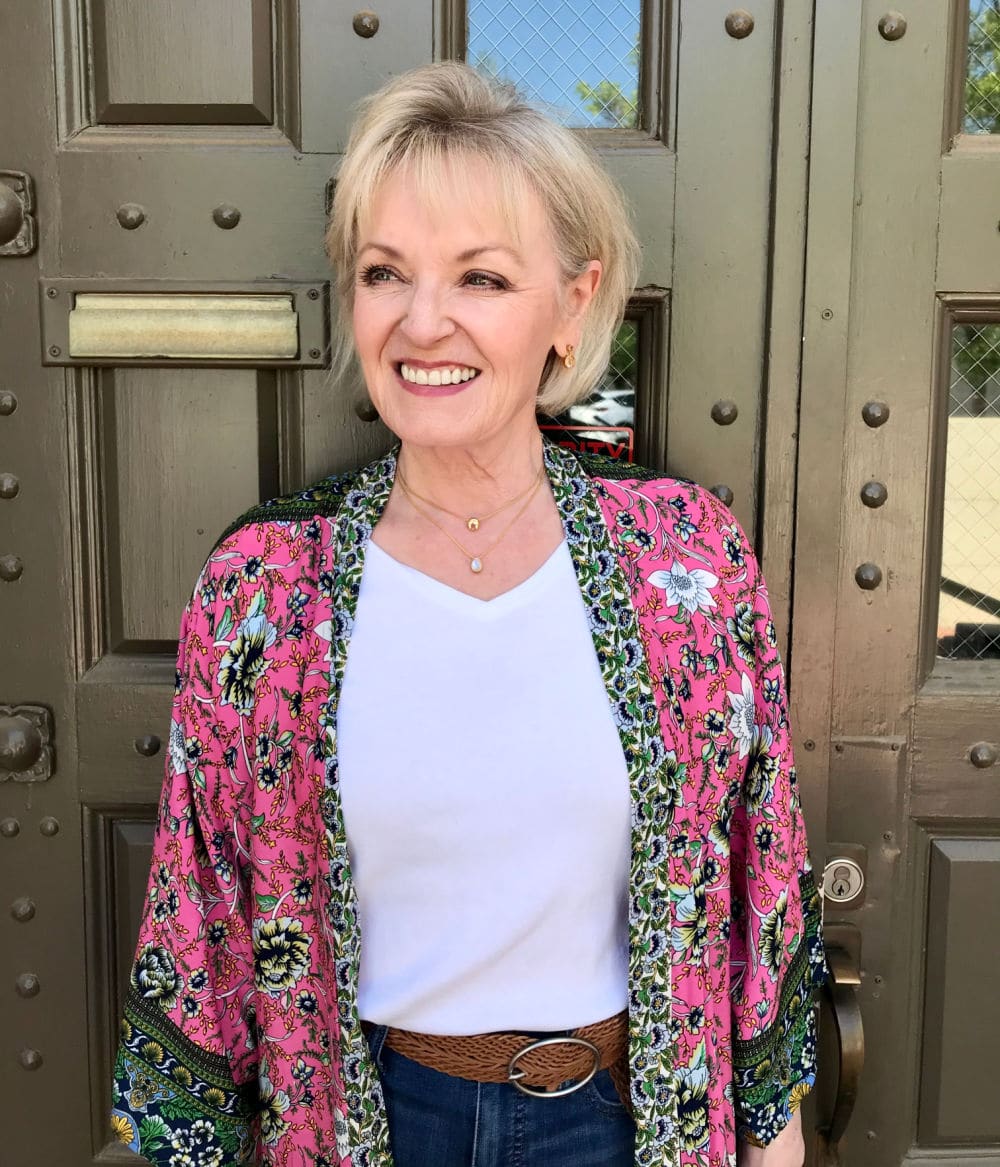 woman in front of green door weaing pink kimono and white tee shirt