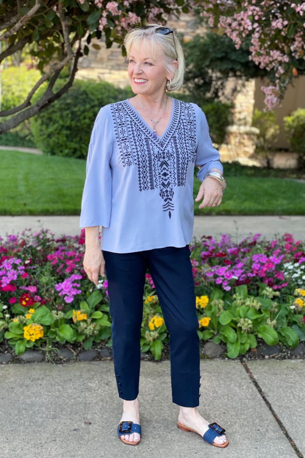 woman wearing denim shoes and boho top with navy pants