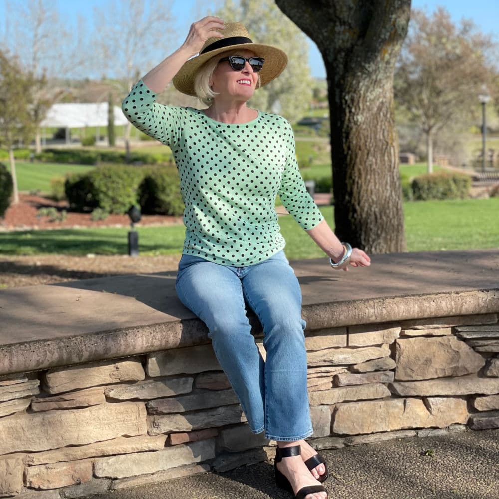 woman wearing straw hat and green polka dot sweater